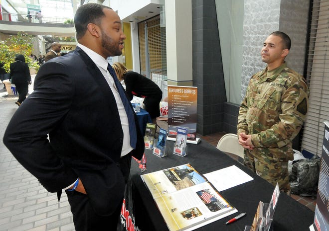 (file) Ryan Wilson, of Burlington Township, talks with Edwin Reyes, of the New Jersey Army National Guard, at the Burlington Center in Burlington Township during a job fair, co-sponsored by Rowan College of Burlington County, on Friday, March 11, 2016.