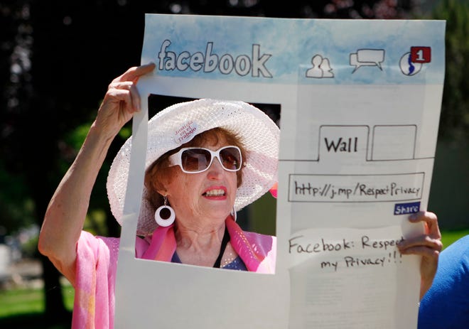 In this June 4, 2010, file photo, Gail Sredanovic, of Raging Grannies, protests Facebook's privacy issues outside Facebook headquarters in Palo Alto, Calif. THE ASSOCIATED PRESS