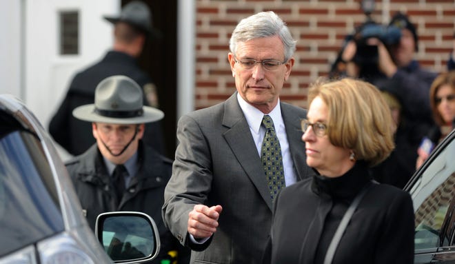 FILE - In this Nov. 2, 2012, file photo, former Penn State athletic director Tim Curley, center, exits District Court following his arraignment in Harrisburg, Pa. Curley pleaded guilty to a misdemeanor child endangerment charge on Monday, March 13, 2017, for his role in the Jerry Sandusky child molestation case, more than five years after the scandal broke. (AP Photo/Bradley C Bower, File)