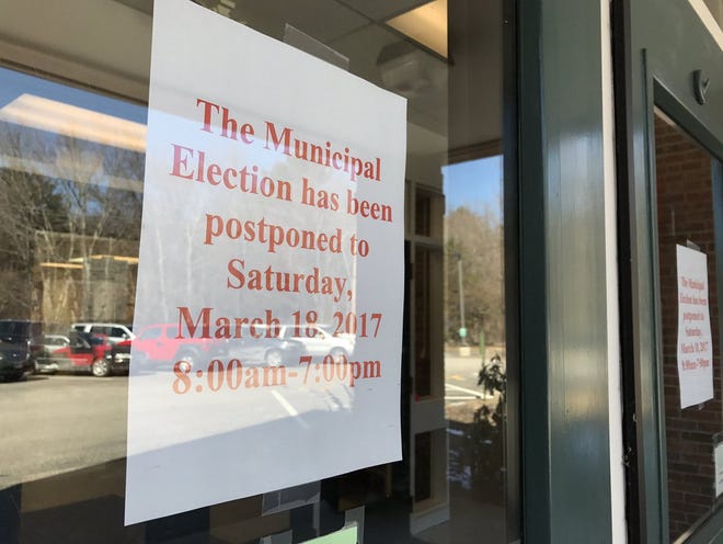 Signs posted Monday at Rye Elementary School announce the town's municipal elections will be moved from Tuesday to Saturday. [Rich Beauchesne/Seacoastonline]