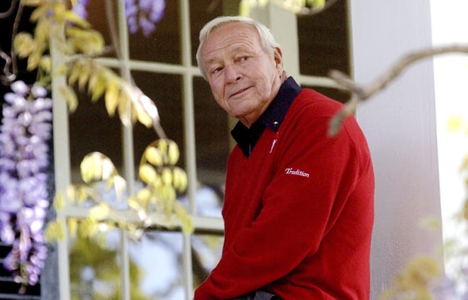 Arnold Palmer sits on clubhouse railing at the Augusta National Golf Club in 2004 in Augusta, Ga. There are sure to be somber moments at the Arnold Palmer Invitational this week, the first time his tournament has been played since his death. [AP Photo / David J. Phillip, File]