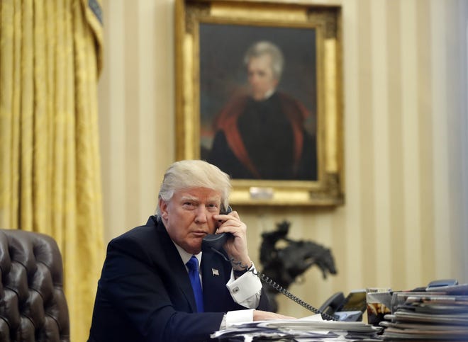 In this Saturday, Jan. 28, 2017 file photo, President Donald Trump speaks on the telephone. THE ASSOCIATED PRESS