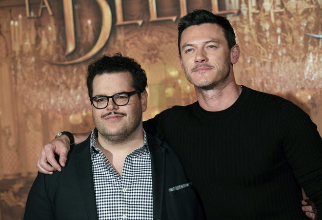 In this Feb. 20, 2017, file photo, actor Josh Gad, left, who plays manservant LeFou and Luke Evans who plays villain Gaston, pose during a promotional event for the movie "Beauty and the Beast", in Paris. THE ASSOCIATED PRESS