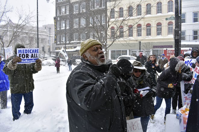 Dohald Bell, of Chicago, speaks at a protest over the proposed health care law in downtown Racine, Wis., on Tuesday, March 14, 2017. A few hundred protesters gathered near House Speaker Paul Ryan's Racine office to protest the American Health Care Act. THE ASSOCIATED PRESS