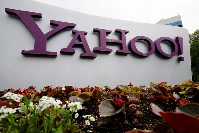 In this April 18, 2011 file photo, the Yahoo logo is seen outside of the offices in Santa Clara, Calif. A law enforcement official says the Justice Department is preparing to announce charges against four defendants, including two officers of Russian security services, in a mega data breach at Yahoo. (AP Photo/Paul Sakuma, File)