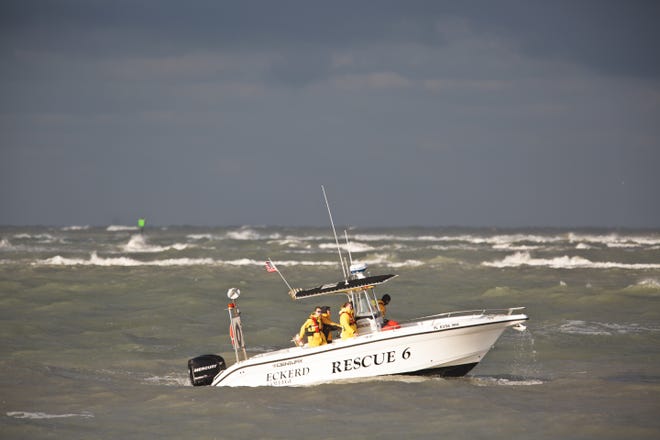 A boat from Eckerd College searches the Pass-A-Grille Channel on Wednesday for a Colorado State University student on spring break and a charter boat crew member who went missing in turbulent Tampa Bay-area waters. [SCOTT KEELER / TAMPA BAY TIMES]
