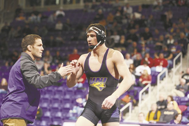 University of Northern Iowa sophomore Drew Foster is congratulated by head coach Doug Schwab after a win at the Mid-American Championships at the McLeod Center in Cedar Falls.