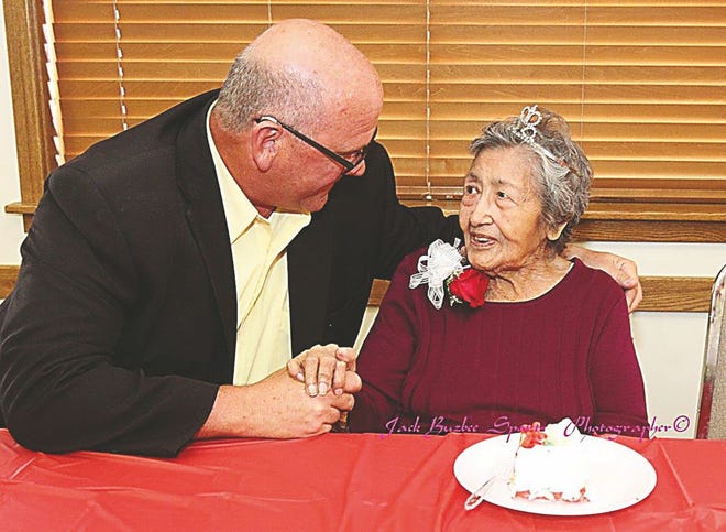 Sally Carroll visits with City Manager Michael McCartney during her 100th birthday celebration Oct. 22, 2016, at the Pawhuska Community Center.
