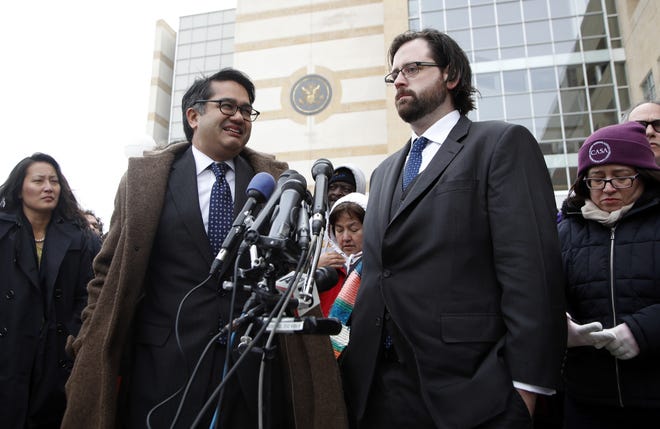 Omar Jadwat of the ACLU, left, and Justin Cox of the National Immigration Law Center, representing the plaintiffs, meet with reporters outside court in Greenbelt, Md., Wednesday, March 15, 2017. A federal judge in Maryland ordered a temporary injuction against President Donald Trump's second travel ban Thursday. THE ASSOCIATED PRESS