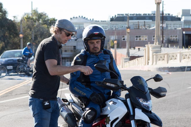Dax Shepard (left) gives some direction to his costar Michael Peña on the set of “CHiPs.” (Primate Pictures)