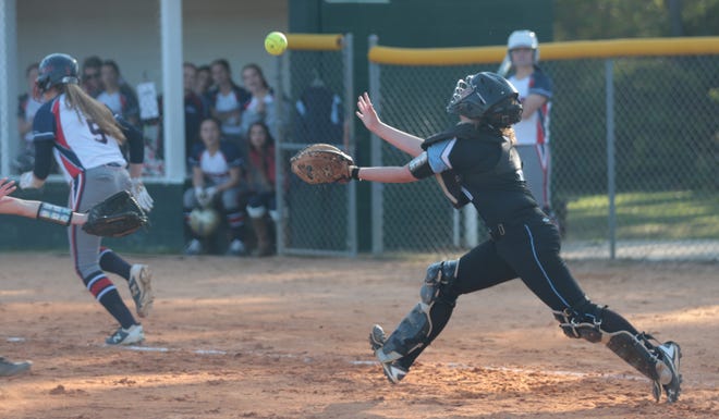 North Bay Haven catcher Ally Lanford chases the ball as Bozeman's Abby Jo Batton runs safely to first. [Patti Blake | The News Herald]