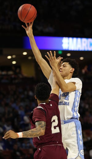 North Carolina's Justin Jackson (44) takes a shot over Zach Lofton (2) of Texas Southern during Friday's NCAA tournament game in Greenville. [JOHN BYRUM/Spartanburg Herald-Journal]