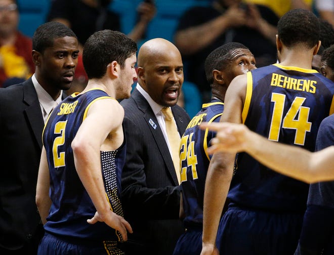 FILE - In this Thursday, March 12, 2015, file photo, California head coach Cuonzo Martin, center, speaks with his team during a timeout in the second half of an NCAA college basketball game against Arizona in the quarterfinals of the Pac-12 conference tournament in Las Vegas. Arizona won 73-51. Martin has a certain way he does things. No staying late after games to rehash film into the wee hours as is customary for so many college basketball coaches, only to return first thing in the morning to do so again. He avoids finger- pointing at one player in the heat of the moment, instead choosing to critique a specific area in which his team struggled while speaking individually with a young man when necessary. Missouri’s new coach learned a lot from a cancer scare 20 years ago. (AP Photo/John Locher, File)