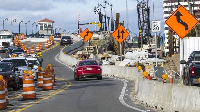 Drivers face a labyrinth of construction clutter and cones as work on the replacement Flagler Memorial Bridge continues Tuesday. The expected completion date for the new bridge has been pushed back to June. (Lannis Waters / Daily News)