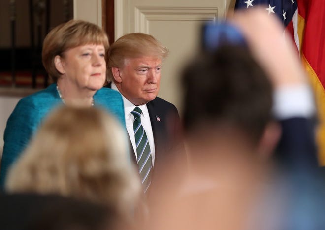 President Donald Trump and German Chancellor Angela Merkel arrive for a joint news conference in the East Room of the White House in Washington, Friday, March 17, 2017. THE ASSOCIATED PRESS