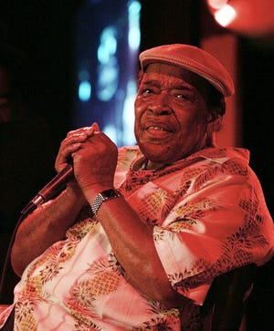 In this 2005 file photo, legendary blues man James Cotton performs at the B.B. King Blues Club in New York City. Cotton, a Grammy Award-winning blues harmonica master whose full-throated sound backed such blues legends as Muddy Waters, Sonny Boy Williamson II and Howlin' Wolf, has died at age 81.
