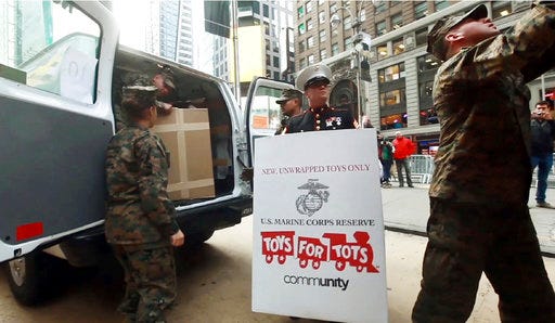 This undated still image from a TV advertisement provided by the U.S. Marine Corps, is part of a new recruitment ad campaign by the Corps, meant to draw millennials by showing Marines as not only strong warriors but good citizens. "Battles Won" is the name of the campaign that includes TV ads and online clips of Marines unloading "Toys for Tots" boxes and real video of a Marine veteran tackling an armed robber. The military's smallest branch is also considering replacing its iconic slogan, "The Few. The Proud. The Marines."