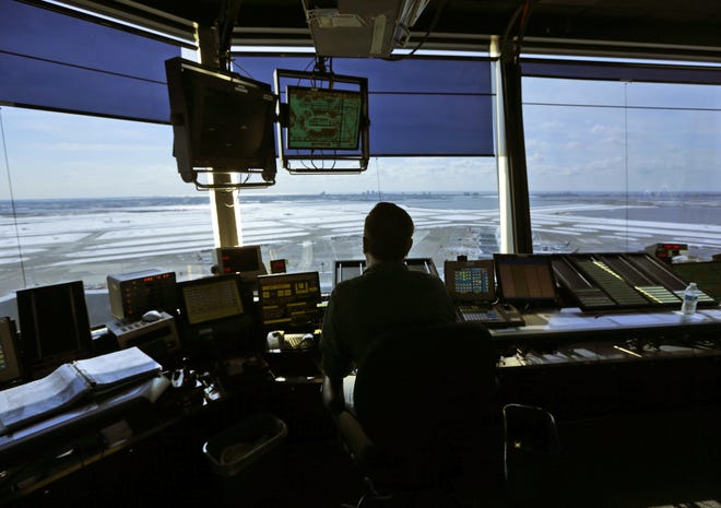 An air-traffic controller works Thursday in the tower at John F. Kennedy International Airport in New York. Airlines support privitization of the job. [ASSOCIATED PRESS / SETH WENIG]