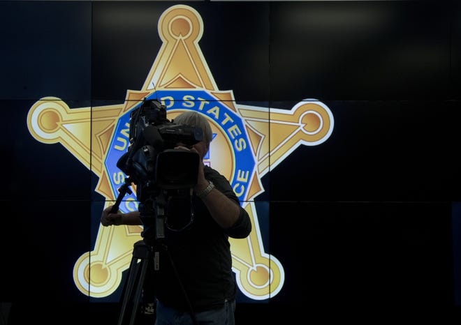 A television cameraman records a news conference in front of the U.S. Secret Service logo, attended by Homeland Security Secretary Jeh Johnson, about the security for the presidential inauguration and activities related to it, Friday, Jan. 13, 2017 at the Multi Agency Communications Center (MACC) in Dulles, Va. THE ASSOCIATED PRESS