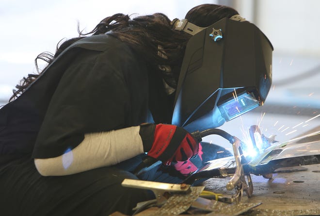Trinea Huyghue welds a fender at Haney Technical Center on Wednesday. [ANDREW WARDLOW/THE NEWS HERALD]