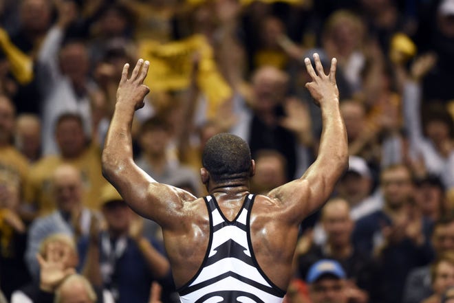 Missouri's J'den Cox holds up three fingers after beating Minnesota's Brett Pfarr 8-2 in the 197-pound championship bout Saturday night at the Scottrade Center in St. Louis. Cox, a senior, became a three-time national champion.