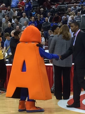 Add A. Tude, the IHSA sportsmanship mascsot, shakes hands with one of the coaches during trophy presentations at the state tournament.