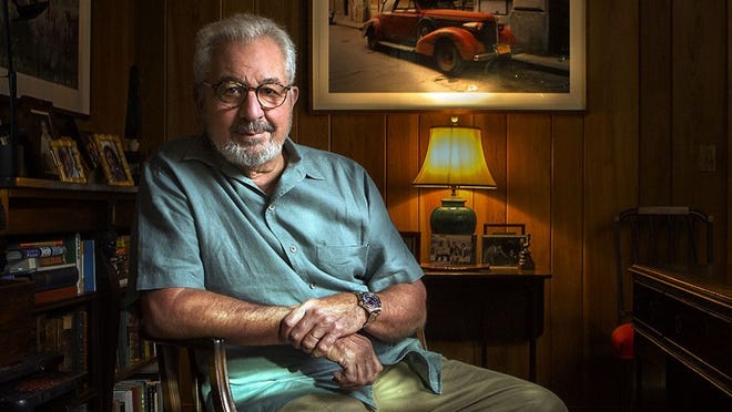 Bob Vila sits in the study of his home on Everglades Island in Palm Beach. Behind him, a painting depicts a vintage car on a street in Cuba, where many residents still drive vehicles dating from before the 1959 communist revolution. (Damon Higgins / Daily News)