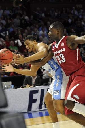 North Carolina's Kennedy Meeks and Arkansas' Moses Kingsley battle for the ball during Sunday's second-round NCAA tournament game in Greenville. [ALEX HICKS JR./SPARTANBURG HERALD-JOURNAL]