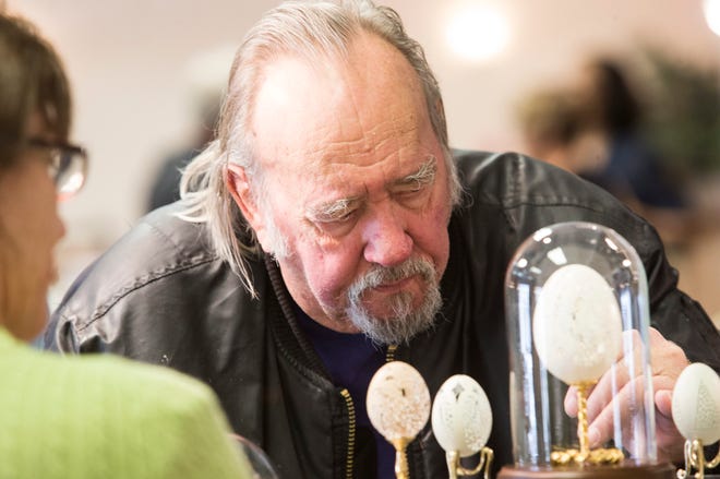 Bill Zima looks at works on display at 2014 The Egg Artistry Show at Midway Village Museum in Rockford. [RRSTAR.COM FILE PHOTO]