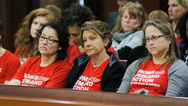 Woman from the group Moms Demand Action watch as the campus Carry bill advances Monday, Feb. 27, 2017, at the legislature in Atlanta. With little fanfare, the House Public Safety and Homeland Security Committee om Monday approved what has become known as the "Campus Carry" bill. Ballinger is the sponsor of HB 280, which allows anyone with a Georgia weapons permit to carry firearms onto most parts of public college and university campuses. (Bob Andres/Atlanta Journal-Constitution via AP)