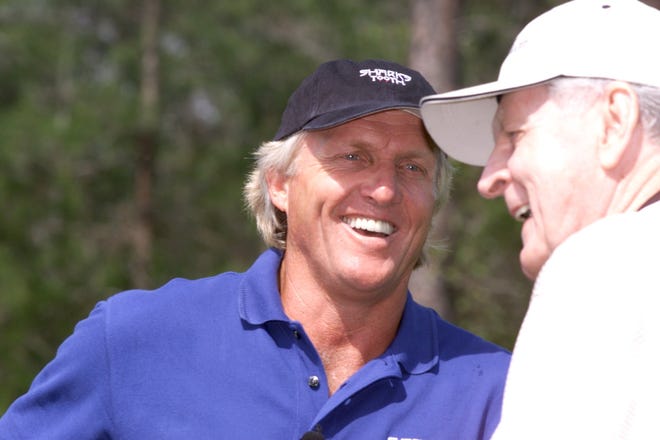 Greg "The Shark" Norman shares a laugh with Karl Grefenstette at Shark's Tooth Golf Club in March 2002. Norman, a 20-time PGA Tour winner and one fo the world's top golfers in the 1980s and '90s, designed the course near Lake Powell. [ROBERT COOPER/NEWS HERALD FILE PHOTO]