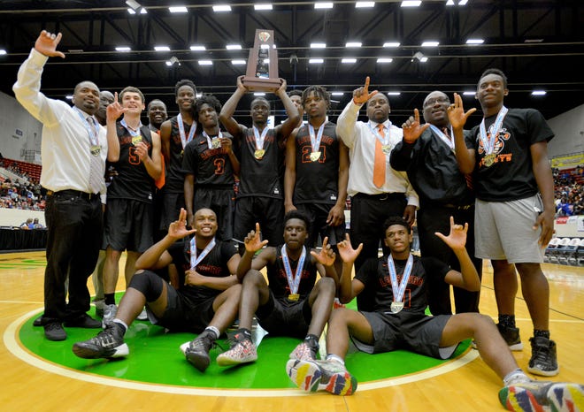 Leesburg poses with the state championship trophy after Leesburg won the Class 6A state championship at The Lakeland Center on March 4. The team will be honored with a parade down Main Street and a ceremony at the school on Thursday. [AMBER RICCINTO / DAILY COMMERCIAL]