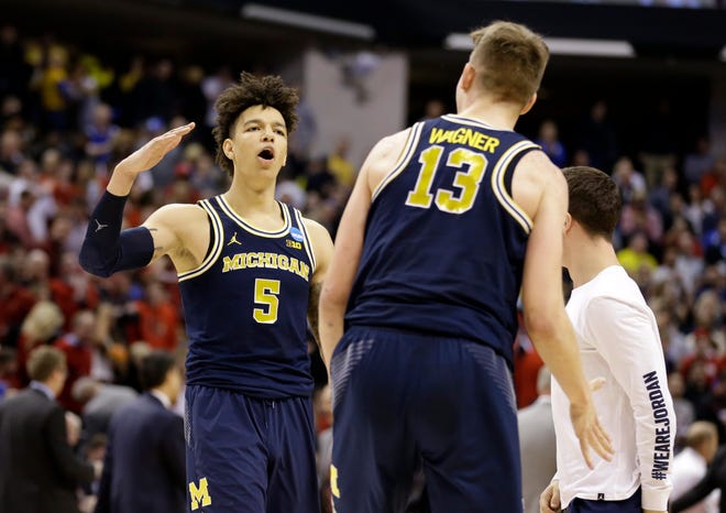 Michigan forward Moritz Wagner (13) and forward D.J. Wilson (5) celebrates a 73-69 win over Louisville in a second-round game in the men’s NCAA college basketball tournament in Indianapolis, Sunday, March 19, 2017. (AP Photo/Michael Conroy)