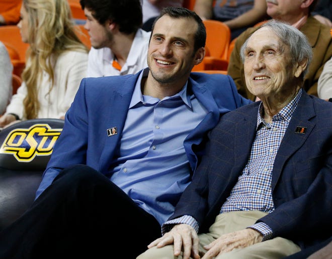 Former Oklahoma State basketball player Doug Gottlieb, left, sits with legendary Cowboys coach Eddie Sutton during a 2016 game at Gallagher-Iba Arena in Stillwater. Gottlieb said he wants to replace Brad Underwood as OSU's next coach. [AP PHOTO]