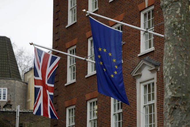 A European and British Union flags hang outside Europe House, the European Parliament's British offices in London, Monday, March 20, 2017. Britain's government will begin the process of leaving the European Union on March 29, starting the clock on the two years in which to complete the most important negotiation for a generation. THE ASSOCIATED PRESS