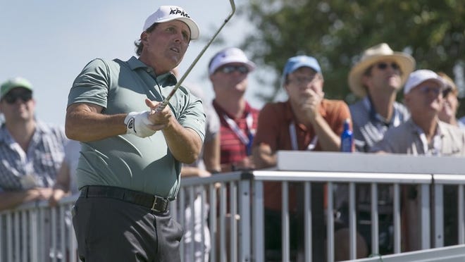 Phil Mickelson, right, plays a practice round as he watches his tee shot on the par 3 7th hole. Tuesday was the last day of practice for the field of top 64 golfers in the world as they prepare for the start of the World Golf Championships Dell Technologies Match Play tournament at Austin Country Club. RALPH BARRERA/AMERICAN-STATESMAN