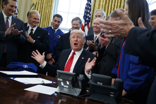 President Donald Trump speaks in the Oval Office of the White House in Washington, Tuesday, March 21, 2017, after signing a bill to increase NASA's budget to $19.5 billion and directs the agency to focus human exploration of deep space and Mars. (AP Photo/Evan Vucci)