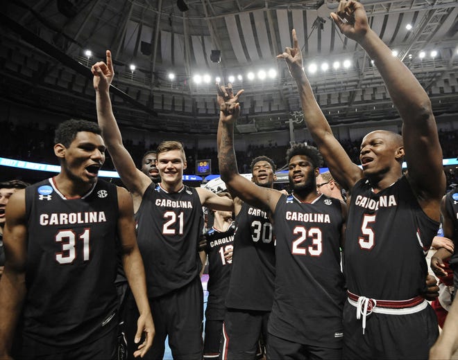 South Carolina players, from left, Jarrell Holliman, Maik Kotsar, Chris Silva, Evan Hinson and TeMarcus Blanton celebrate after a second-round game against Duke in the NCAA men's college basketball tournament in Greenville, S.C., Sunday, March 19, 2017. (AP Photo/Rainier Ehrhardt)
