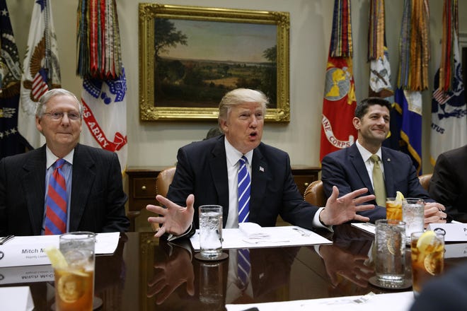 This Wednesday, March 1, 2017, file photo shows President Donald Trump, flanked by Senate Majority Leader Mitch McConnell of Ky., left, and House Speaker Paul Ryan of Wis., right as he speaks during a meeting with House and Senate leadership in the Roosevelt Room of the White House in Washington. THE ASSOCIATED PRESS