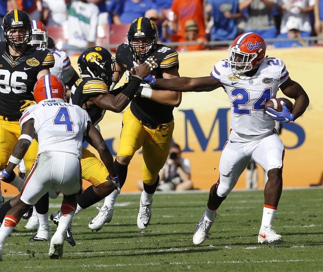 Florida running back Mark Thompson breaks away from Iowa defenders for an 85-yard touchdown off a screen pass during the first half of the Outback Bowl at Raymond James Stadium in Tampa on Jan. 2. [Brad McClenny/Staff photographer]