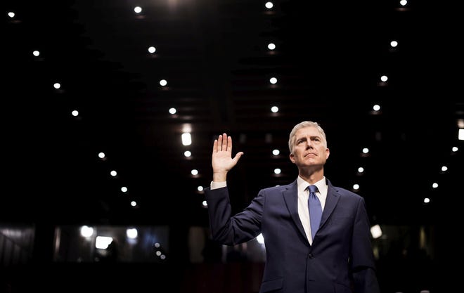 Neil Gorsuch, President Donald Trump's nominee for the Supreme Court, is sworn in Monday on Capitol Hill. In a 13-minute introductory address during his confirmation hearing, Gorsuch tried to reassure senators he was a mainstream jurist, who was in the majority in 99 percent of the 10 years of cases he decided on the appeals court. MELINA MARA/WASHINGTON POST