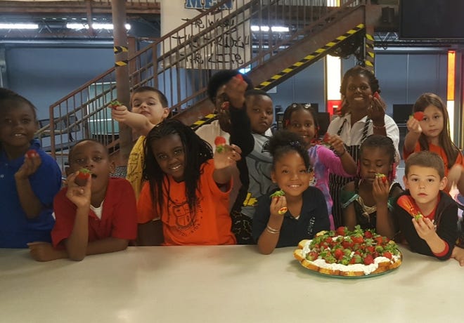 The Roaming Gourmet, Ze'Carter, with first and second grade students from The Genesis Center. [SUBMITTED]