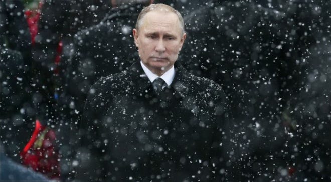FILE - In this Feb. 23 file photo, snow falls as Russian President Vladimir Putin attends a wreath-laying ceremony marking the Defenders of the Fatherland Day at the Tomb of the Unknown Soldier in Moscow, Russia. .[AP Photo/Ivan Sekretarev, file]