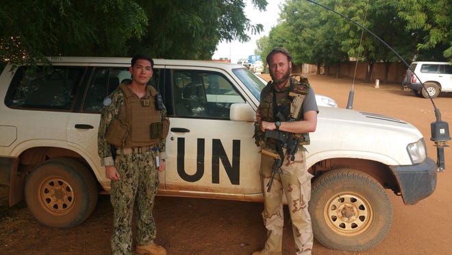 Lt. Andrew Lang (left) stands with a United Nations soldier who shared duty in the challenging security environment near the Sahara desert.