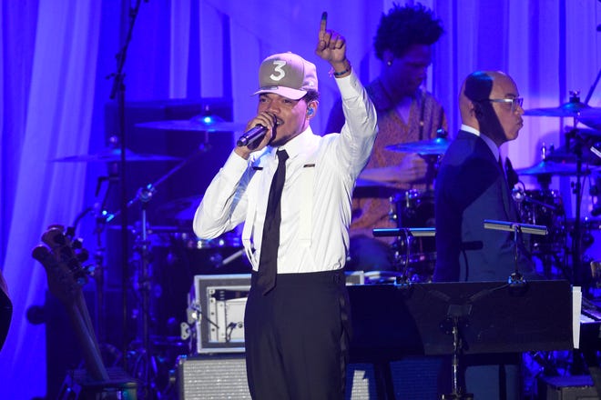 FILE - In this Saturday, Feb. 11, 2017, file photo, Chance the Rapper performs at the Clive Davis and The Recording Academy Pre-Grammy Gala at the Beverly Hilton Hotel in Beverly Hills, Calif. Grammy-winning artist Chance the Rapper is planning a return to his hometown of Chicago summer 2017 to headline the Lollapalooza music festival. (Photo by Chris Pizzello/Invision/AP, File)