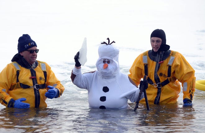 Marge Bonhauser was dressed as Olaf from "Frozen" in a recent year's Polar Plunge into Canandaigua Lake. Here she's flanked by Cheshire firefighters. [MESSENGER POST MEDIA FILE PHOTO]