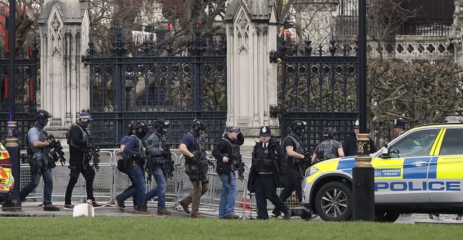 Armed police officers enter the Houses of Parliament in London, Wednesday, March 23, 2017 after the House of Commons sitting was suspended as witnesses reported sounds like gunfire outside. THE ASSOCIATED PRESS
