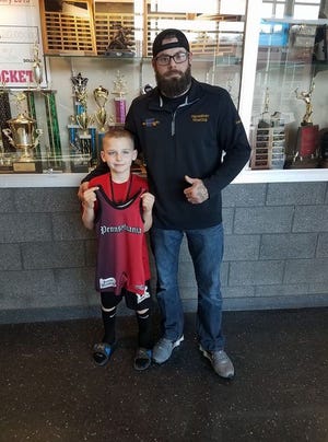 Anthony Ausherman, left, is pictured with youth wrestling coach Jeff Hickok after a recent tournament.