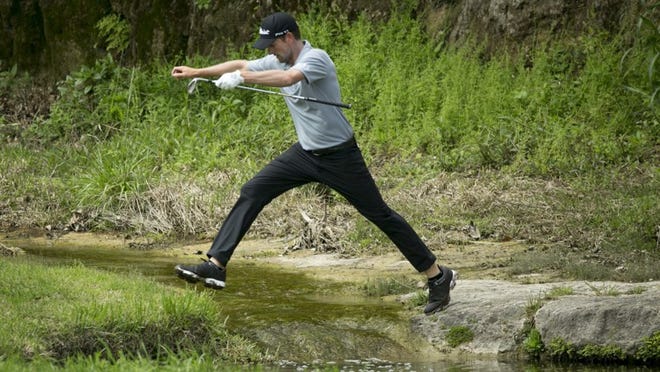 Webb Simpson jumps across a creek Wednesday after hitting a shot on the third hole at the WGC-Dell Technologies Match Play event at Austin Country Club. Simpson lost to Dustin Johnson 5 and 3.