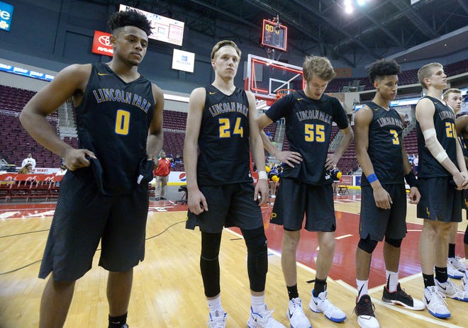Lincoln Park players wait to receive their runner-up medals at the end of the Leopard's loss to Neumann-Goretti in the PIAA Class 3A boys basketball championship game Thursday night at the Giant Center in Hershey.